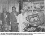 Tilak Rawal (right), govenor of Nepal Rastra Bank, releases a silver coin worth Rs 250 to mark the fiftieth anniversary of Marwa